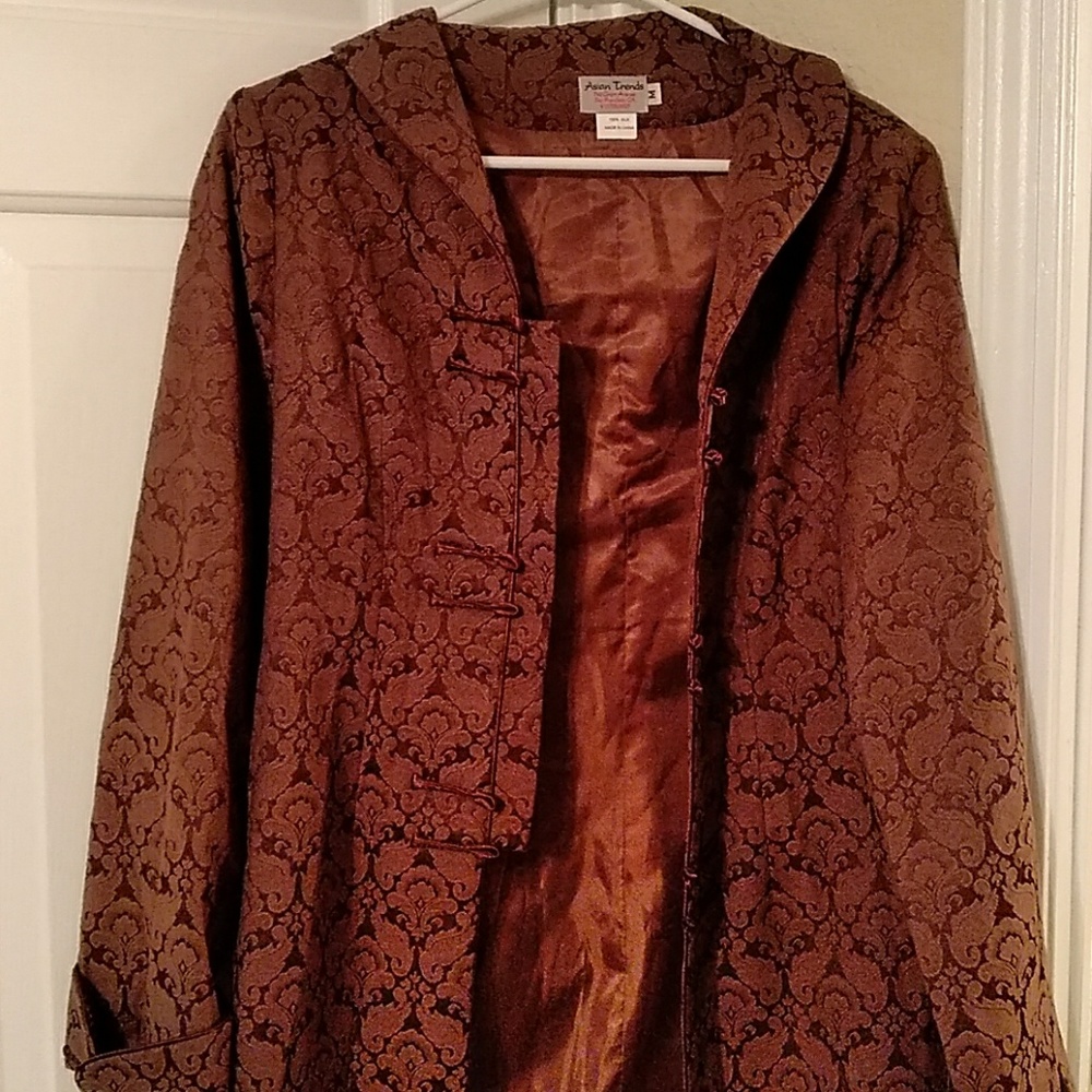 Mid length brown stiched coat with decorative clas